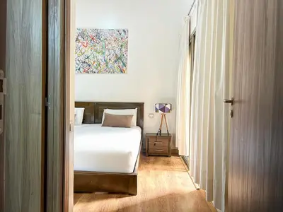 a bedroom with a bed and a painting on the wall at Apartment in City Center - Gueliz in Marrakech