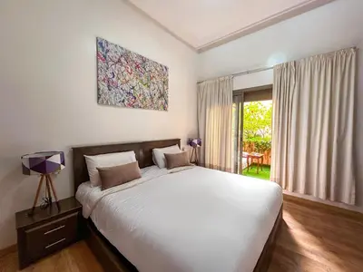 a bedroom with a large white bed and a window at Apartment in City Center - Gueliz in Marrakech
