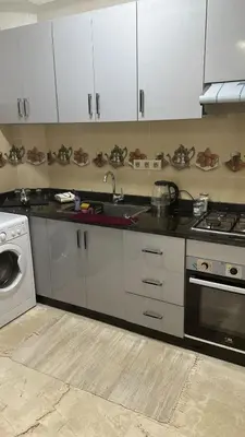 a kitchen with a sink and a washing machine at appartement elegant in Marrakech