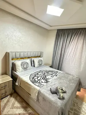 a bedroom with a large bed with a window at appartement elegant in Marrakech