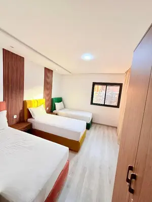 a hotel room with two beds and a window at N17 Agréable Confortable & Près De Gueliz in Marrakech