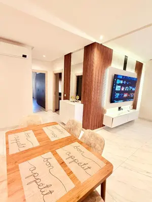 a dining room with a wooden table and chairs at N17 Agréable Confortable & Près De Gueliz in Marrakech