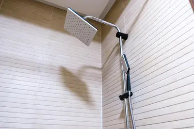 a shower head on the wall of a bathroom at 2BR Modern Apt 2min M Avenue Balcony Fiber WiFi 2 Pools 24 7 Security Hivernage in Marrakech