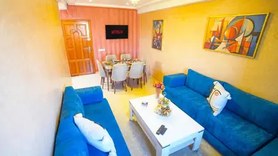 a living room with a blue couch and a table at Marrakech Luxury apartment in Marrakech