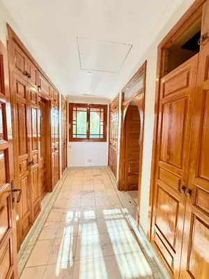 a hallway with wooden doors and a tile floor at VILLA 34 - 4 Masters, Moroccan Charm & Modern Comfort with Private Pool in Marrakech