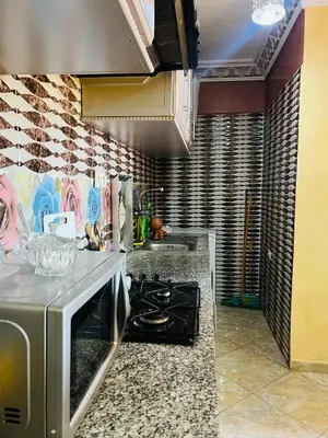 a kitchen with a stove and a counter top at Apartment Msholidays 1 CH Marrakech pool in Marrakech