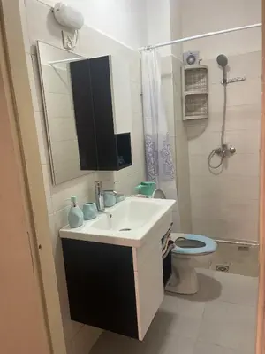 a bathroom with a sink and a toilet and a mirror at Au cœur de la ville ocre in Marrakech