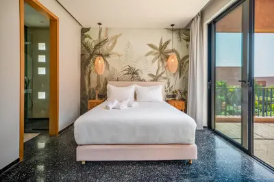 a bedroom with a white bed with two stuffed animals on it at Sublime Villa Neuve Marrakech - Piscine Chauffée in Marrakech
