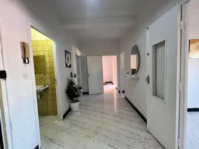 a hallway with a bathroom with a sink and a mirror at Résidence zitouna in Marrakech