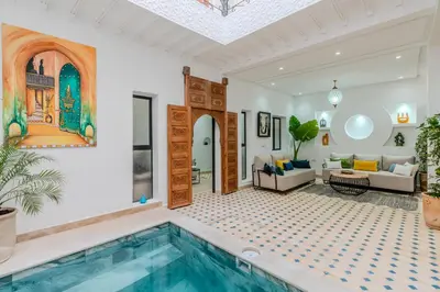a villa with a swimming pool in a living room at Riad Dar Amarena Exclusif BreakFast in Marrakech