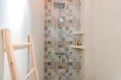 a bathroom with a shower with a mosaic wall at Riad Dar Amarena Exclusif BreakFast in Marrakech