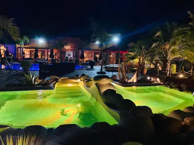 a water park at night with green lights at Eden Lodges & SPA-Boutique Hôtel de Luxe in Marrakech