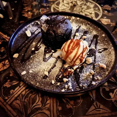 a plate with a chocolate dessert on a table at Eden Lodges & SPA-Boutique Hôtel de Luxe in Marrakech