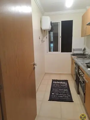 a kitchen with a door with a sign on the floor at Charming Marrakech apartment in Marrakech