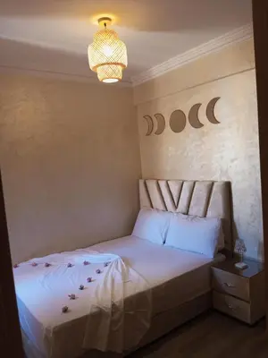a bedroom with a bed and a chandelier at Charming Marrakech apartment in Marrakech