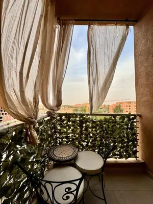 a window with a table and two chairs in a room at Charming appartement 1 bed in Guéliz in Marrakech