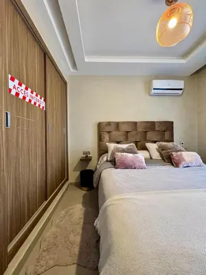 a bedroom with two beds in a room with at Charming appartement 1 bed in Guéliz in Marrakech