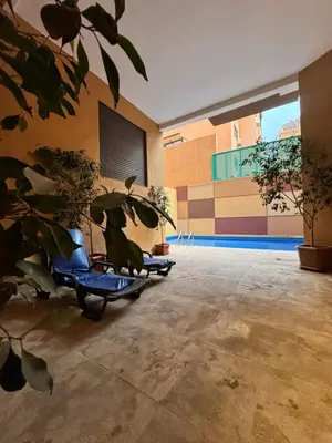 two scooters parked in a room with a plant at Charming appartement 1 bed in Guéliz in Marrakech