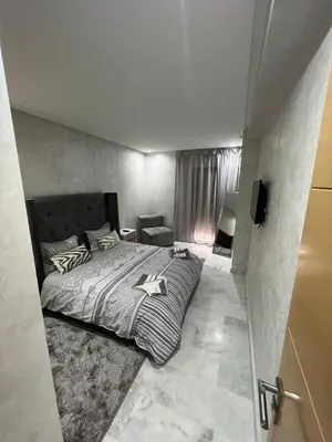 a bedroom with a large bed and a window at Superbe appartement T2 plein centre de Marrakech in Marrakech
