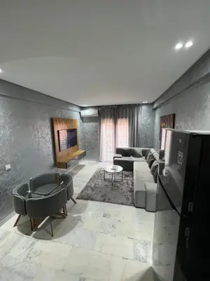 a living room with a couch and a tv at Superbe appartement T2 plein centre de Marrakech in Marrakech