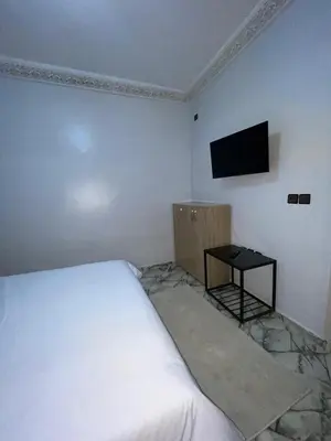a bedroom with a bed and a television on the wall at Marrakech Oasis Retreat in Marrakech