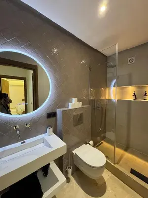 a bathroom with a toilet and a sink and a mirror at Prestige cocon in Marrakech
