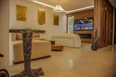 a living room with a table and a couch at Villa Athena 4 chambres piscine privée et jaccuzi in Marrakech