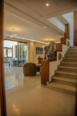a lobby with a staircase and a living room at Villa Athena 4 chambres piscine privée et jaccuzi in Marrakech