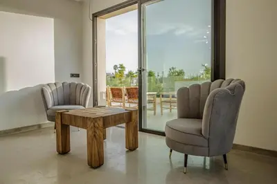 a living room with two chairs and a coffee table at Villa Athena 4 chambres piscine privée et jaccuzi in Marrakech