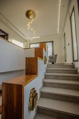 a staircase in a house with a chair and a table at Villa Athena 4 chambres piscine privée et jaccuzi in Marrakech