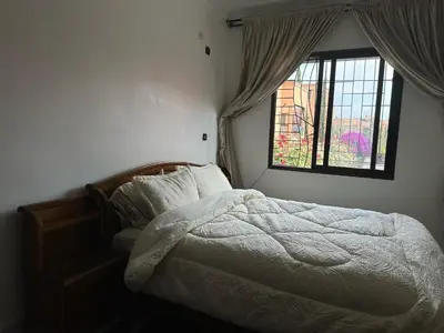 a bedroom with a bed and a window at appartement Lamrani in Marrakech
