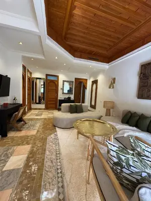a living room with a couch and a table at Traditional Moroccan Flat in Palmeraie in Marrakech