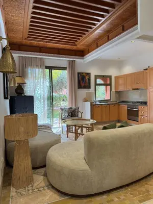 a living room with a couch and a table at Traditional Moroccan Flat in Palmeraie in Marrakech