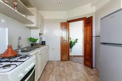 a kitchen with a sink and a stove top oven at Artisan's Hideaway Marrakech in Marrakech