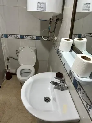 a bathroom with a white sink and a toilet at Le Marrakchi 37 au coeur de l'hivernage pour les familles acte de mariage obligatoire in Marrakech