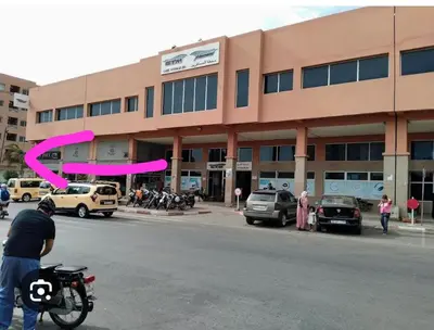 a man on a motorcycle in front of a building at Le Marrakchi 37 au coeur de l'hivernage pour les familles acte de mariage obligatoire in Marrakech