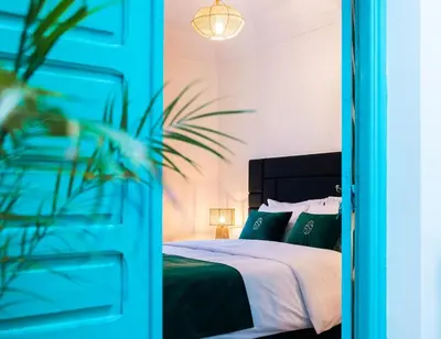 a bedroom with a bed with green pillows at Luxury Riad, Marrakech, Pool, Free Airport Shuttle, Dar Bassidi in Marrakech