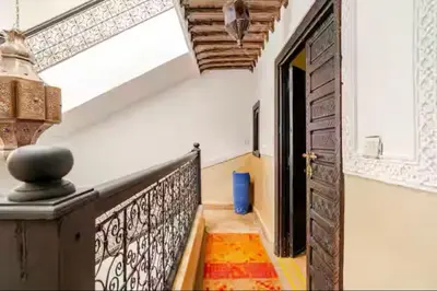 a hallway with a stairway with a door and a room at Riad Amani in Marrakech