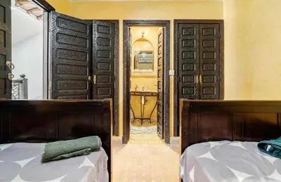 a bedroom with a bed and an open door at Riad Amani in Marrakech