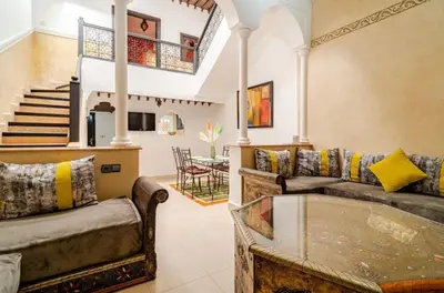 a living room with two couches and a table at Riad Amani in Marrakech