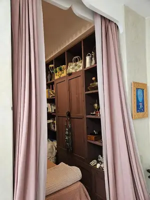 a curtain in a room with a book shelf at Séjour au cœur de la medina in Marrakech