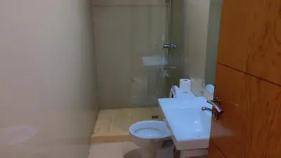 a bathroom with a toilet and a glass shower at Hivernage Cosy in Marrakech