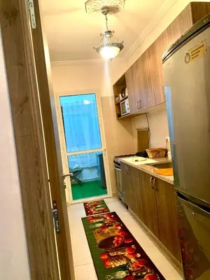 a kitchen with a floor with a rug on the floor at Appartement Marrakech in Marrakech