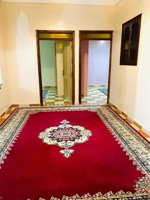a room with a red rug on the floor at Aéroport, Appartement in Marrakech