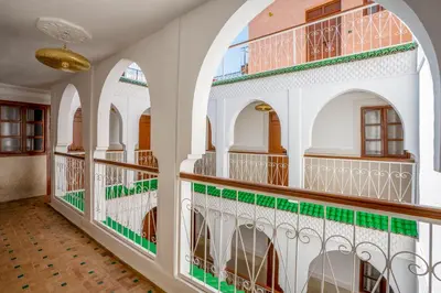 a room with arches and balconies in a building at Riad Ilyan & Spa in Marrakech