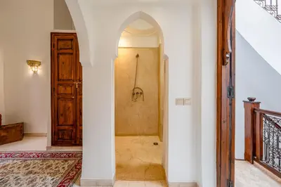 a bathroom with a shower in the middle of a room at L'Alchimiste - Riad Entier à 10 minutes Jemaa El Fna in Marrakech