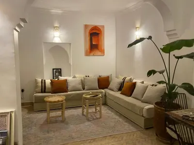 a living room with a couch and a table at L'Alchimiste - Riad Entier à 10 minutes Jemaa El Fna in Marrakech
