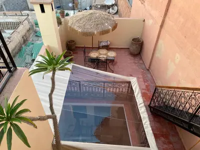 an overhead view of a balcony with a patio with a pool at L'Alchimiste - Riad Entier à 10 minutes Jemaa El Fna in Marrakech