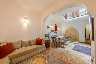 a living room with a couch and a table at L'Alchimiste - Riad Entier à 10 minutes Jemaa El Fna in Marrakech
