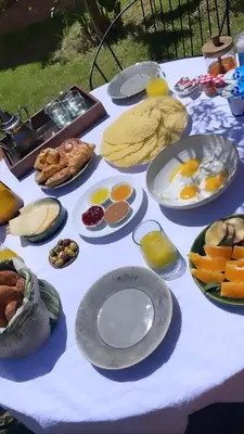 a table with many plates of food on it at Marrakech Apartment with garden Marrakech in Marrakech